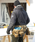Man wearing Heavy Duty Built Tough Tactical Tool Belt With Large Pouch Capacity Adjustable Fit And Lumbar Support in Coyote Tan