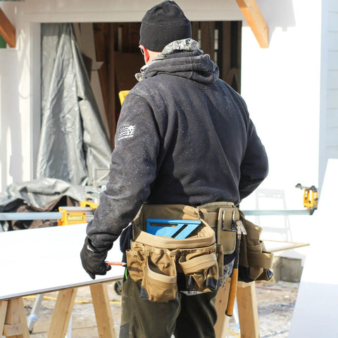 Man wearing Heavy Duty Built Tough Tactical Tool Belt With Large Pouch Capacity Adjustable Fit And Lumbar Support in Coyote Tan