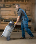 Man maneuvering a 13 Gallon Air Compressor With 2 HP Motor And Oil Free Tank, Ultra Quiet 66dB Operation, in a workshop setting.