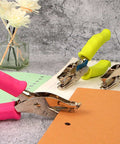 12 Piece Multicolor Single Hole Puncher Set for craft paper with red, yellow, blue grips, shown on desk with notebooks for precise holes