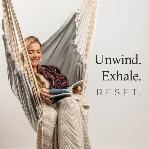 Woman reading while relaxing in a Chill Out In A Cozy Full Body Hammock Chair With Foot Rest For Indoor Outdoor Relaxation