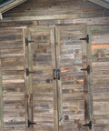 Wooden shed with Six Pack 5 Inch T Shape Strap Hinges With Screws, classic black decorative gate hinges installed on doors.