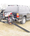 Dirt Bike Hitch Carrier With Ramp For 2 Inch Class III And IV Hitches, Up To 500 Lb Capacity, Includes Ramp And Four Tie Down Eyelets For Secure Motorcycle Transport attached to SUV with motorcycle