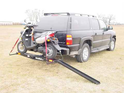 Dirt Bike Hitch Carrier With Ramp For 2 Inch Class III And IV Hitches, Up To 500 Lb Capacity, Includes Ramp And Four Tie Down Eyelets For Secure Motorcycle Transport attached to SUV with motorcycle