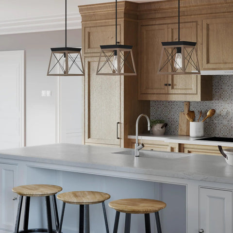 Coastal 1-Light Mini Pendant in Antique Bronze for Rustic Farmhouse Vibe above a kitchen island with wooden stools.
