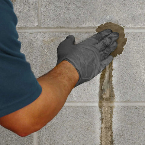Person applying Fast Acting Hydraulic Water Stop Cement For Patching Leaks In Concrete And Masonry, Sets In 3 To 5 Minutes, Ideal For Pools