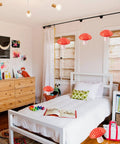 Bedroom with Six Pack Mushroom Paper Lanterns Set For Party Decor And Nursery Ornaments 3D Woodland Mushrooms in orange-red color.
