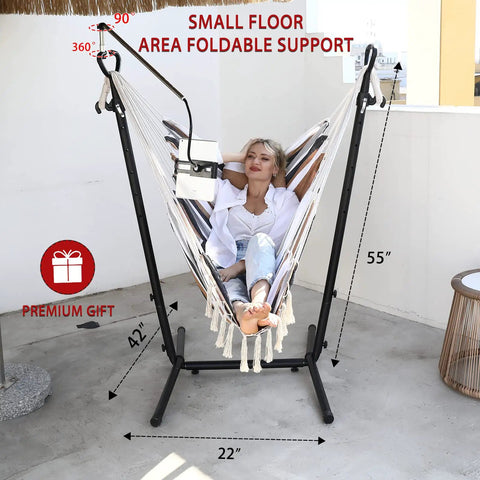 Double Hammock Chair With Stand in Boho Bohemian Style with Tassels and Phone Holder in use on a patio.