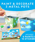 Kids Flower And Herb Gardening Kit with three stainless steel pots being painted with flowers and clouds, paint set and stickers included