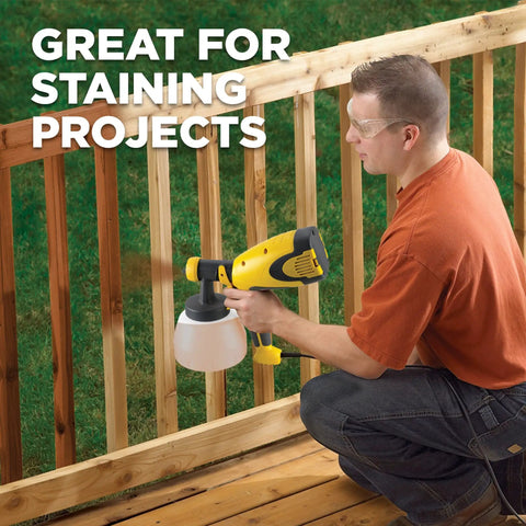 Person using Control Spray Double Duty HVLP Stain Sprayer for staining outdoor wooden railing, achieving smooth, even finish