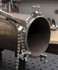 Close-up of Pipe Alignment Chain Pliers Built Tough For Precise Welding with 48 inch chain attached to large metal pipe.