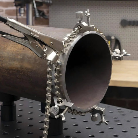 Close-up of Pipe Alignment Chain Pliers Built Tough For Precise Welding with 48 inch chain attached to large metal pipe.