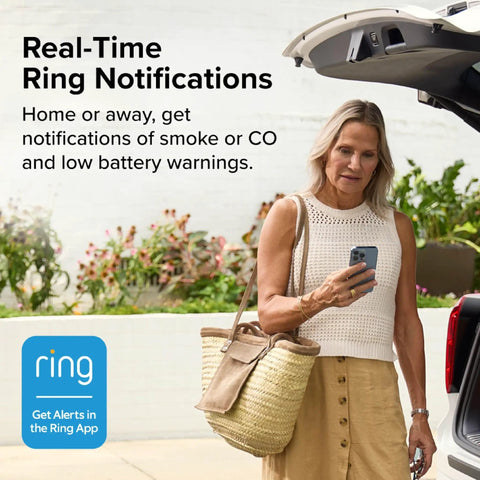 Woman using Smart Smoke And Carbon Monoxide Detector With Ring App Real Time Alerts Wire Free Interconnect AA Battery Powered Doubles Detection