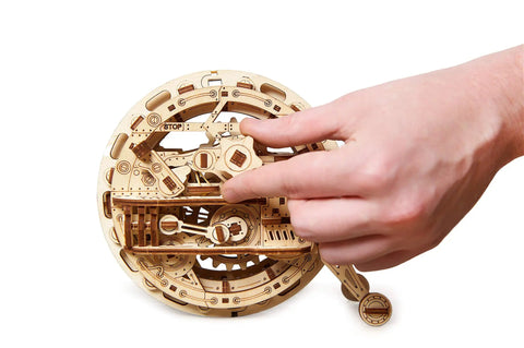 Mechanical Wooden 3D Puzzle Model Monowheel Construction Set For Gearhead Builders With A Steampunk Skeleton Showcasing Moving Dope Gears Durable Outdoor Ready So You Can Roll It On The Street Or Desk A Fun STEM Toy, wooden monowheel in hand