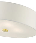 Meridian Collection 4-Light Semi-Flush Mount Ceiling Light With Off-White Fabric Shade In Satin Brass Finish, close-up view.