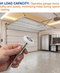 Hand holding a roller from the 10 Pack 7 Inch Stem 2 Inch Sealed Nylon Garage Door Rollers Ultra Quiet Long Lasting High Load Uses 6200 Double Seals Precision Bearings For Home And Commercial Use against a garage background.