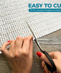 Cream open weave rug pad being cut to size for unique fits, ideal for Keeps Rugs Anchored Solid On Hardwood Or Tile Floors Dropping The Slide Hassle.