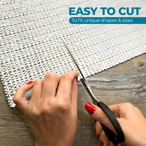 Cream open weave rug pad being cut to size for unique fits, ideal for Keeps Rugs Anchored Solid On Hardwood Or Tile Floors Dropping The Slide Hassle.