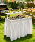 Two Tier Folding Ice Table With Drain And Detachable Skirt at BBQ party, filled with drinks and ice, surrounded by outdoor decor.