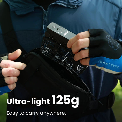 Person inserting Foldable Mini Drone with HDR video into a pouch, showcasing compact and lightweight design and ease of carrying.