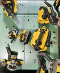 DeWalt cordless power tools and vacuum attachments mounted on a cabinet; yellow and black devices, seven items