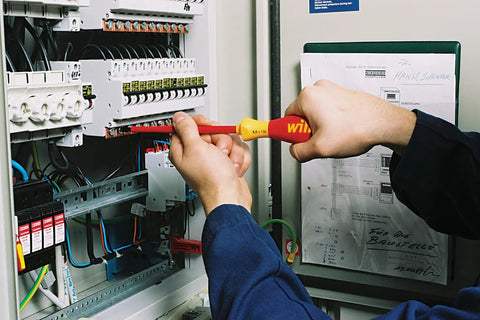 Technician using Insulated SoftFinish 7 Piece Screwdriver Set Pro Grade VDE Tested Up To 1000V, Slotted 3.5 5.5 6.5mm in panel wiring