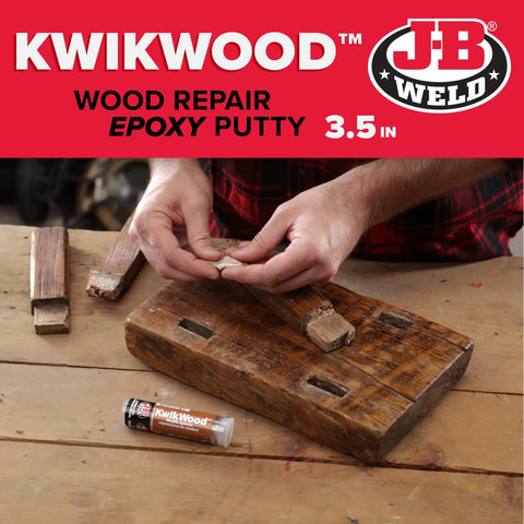 Person using KwikWood Wood Repair Epoxy Putty Stick 1 Oz Beige Tan For Rotted Wood Repairs on a wooden board.
