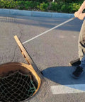 Heavy Duty Stainless Steel T Hook Drain Grabber For Manhole Covers And Heavy Grates Built Like A Tank in use to lift a manhole cover.