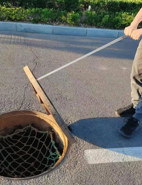 Heavy Duty Stainless Steel T Hook Drain Grabber For Manhole Covers And Heavy Grates Built Like A Tank in use to lift a manhole cover.
