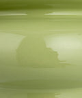 Close-up of celery green stoneware base of the Stoneware Table Lamp In Celery Green With Linen Drum Shade Modern Boho Style Lighting.