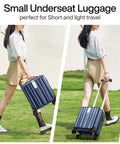 Woman carrying a 14 Inch Underseat Carry On Luggage With Wheels Hard Shell Carry On Suitcase Lightweight Weekender Travel Bag Dark Blue.