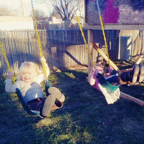 Two children playing on 2 Pack Heavy Duty Kids Swing Seat Set With 66 Inch Chain Plastic Coated For Outdoor Playground Replacement Includes Safety Snap Hooks And EVA Seats That Supports Up To 250 Lbs Backyard Ready.