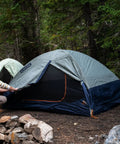 Person setting up Late Start 2P Backpacking Tent for Two People, Lightweight Camping Shelter with Quickcorner Pole Sleeves in forest