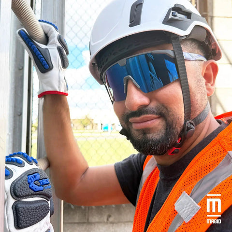 Worker wearing Badass Semi Frameless Safety Glasses With Ansi Z87 Certified features, blue mirrored lenses, and hard hat.