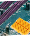 Plug And Play Solderless Breadboard Kit With Six Compact Yellow Protoboard Panels for electronics crafting on a circuit board.