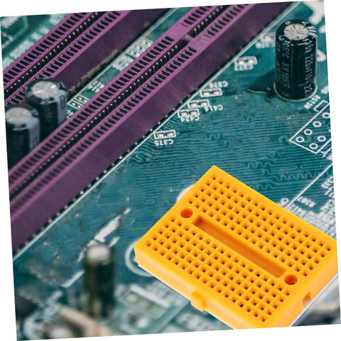 Plug And Play Solderless Breadboard Kit With Six Compact Yellow Protoboard Panels for electronics crafting on a circuit board.