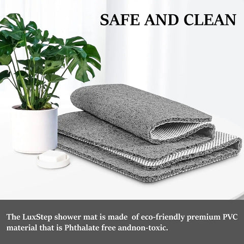 Super Chill Non Slip Shower Mat With Quick Dry Drain Holes And Sticky Traction Phthalate Free PVC Bathroom Must Have Quick Drying Loofah Texture Grey 24X16 Inches Plus Drain folded with plant background.