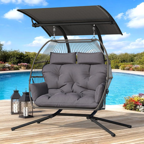 Oversized Double Hanging Swing Chair With Removable Canopy And Cushion in grey by a pool.