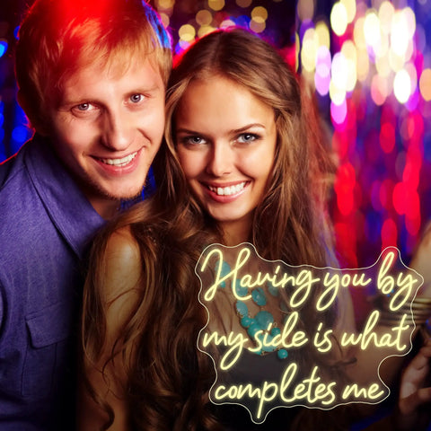 Having You By My Side Is What Completes Me neon sign in warm white light at a lively party background, perfect for events and decor.
