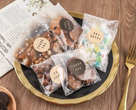4x4 Cookie Bags With Thank You Stickers, Self Sealing Clear Cellophane Bags For Cookies And Treats on a plate