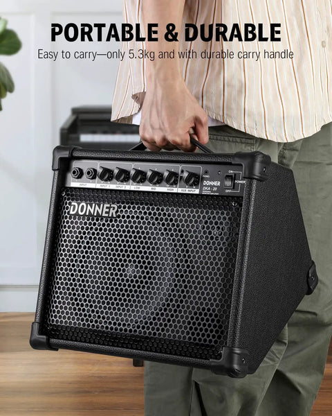 Person holding a 20 Watt Keyboard Amplifier With Dual 8 Inch Woofer And 2 Inch Tweeter AUX In And Two Channel Output.