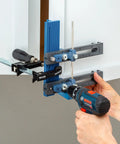 Cabinet Hardware Jig And Pull Drill Guide Pro For Easy Install being used to align handle holes on white cabinet