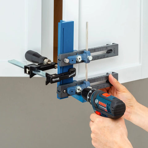 Cabinet Hardware Jig And Pull Drill Guide Pro For Easy Install being used to align handle holes on white cabinet