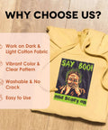 Yellow hoodie on wood floor with graphic design 'Say Boo!' highlighting 11x17 Inch Dark Fabric Heat Transfer Paper For Inkjet Printers Pack Of 10 Sheets For Iron On Or Heat Press Transfer To Custom T Shirts Totes And Bags Like A Pro qualities.