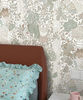 Bed against kid friendly peel and stick wallpaper with boho woodland forest vibe for cabinets and nursery walls removable decor.