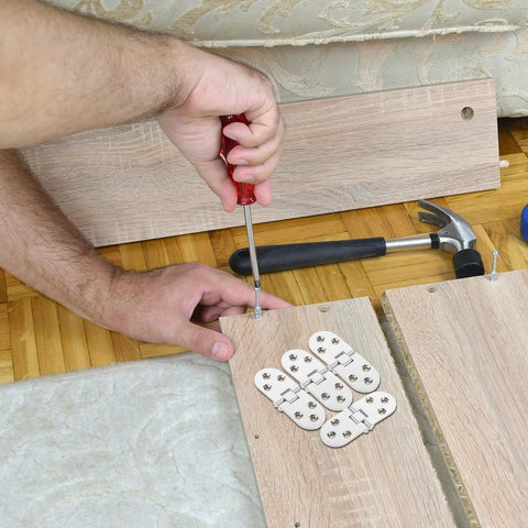 Hands installing Beefy Heavy Duty Cabinet Door Hinges Set 4 Pcs Zinc Alloy Small Craft Hinges For Drawing Board on wood panel.