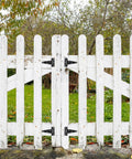 White wooden fence with Ten Pack 4 Inch T Strap Tee Hinge Heavy Duty Black Barn Door Hinges for garden doors, outdoor installation view.
