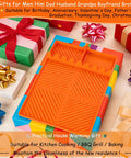 Silicone Griddle And Grill Mat With Drip Pad amidst colorful gift boxes, perfect BBQ gift for men.