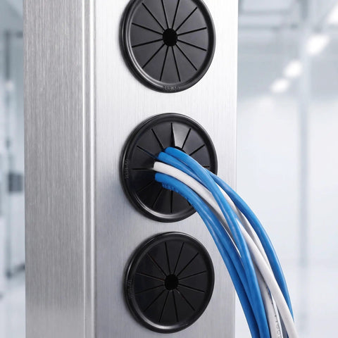 Check These 10 Pack Black Cable Grommets For Your Desk. Petalshaped Design Makes Wiring A Breeze With Secure Grip Locking Tabs To Save The Day And Keep Cords Safe From Damage While Styling Out Your Setup. black nylon cable grommets on brushed metal panel with blue and white wires