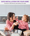 Mother and child in kitchen wearing matching red checkered shirts, baking together with a rolling pin and eggs nearby.